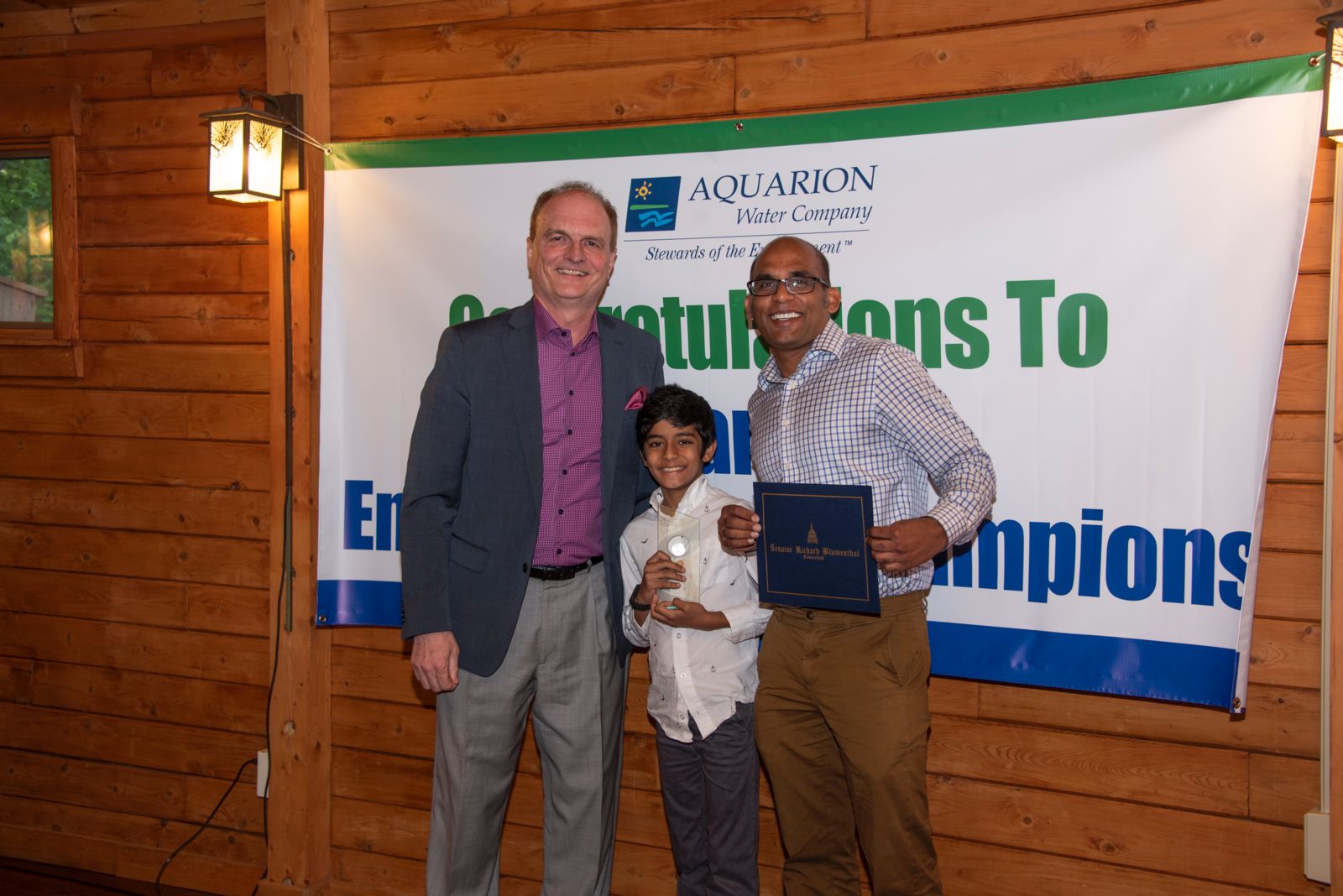 Aquarion President and CEO Charles Firlotte and Nishant Jain and BJ Jain (Accepting for Raina Jain)