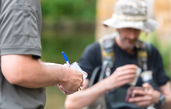 person checking fishing license and permit